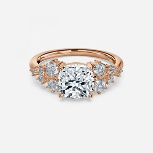 Jessica cushion cut rose gold cluster ring, front view showing starburst round and baguette accent clusters