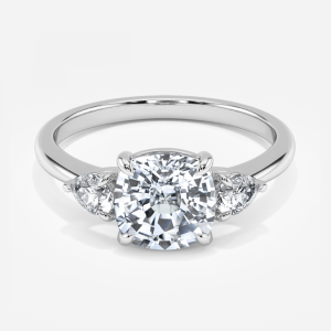 Renai cushion cut white gold three stone ring, front view showing pear side stones pointing outward and cushion center