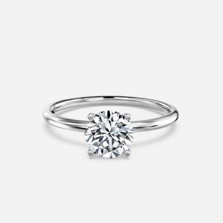 Adaya round cut white gold solitaire ring, front view showing slender plain band and four claw prong setting